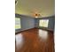 Spacious bedroom featuring wood floors, natural light, and a ceiling fan at 17329 Se 115Th Ter, Summerfield, FL 34491