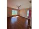 Bedroom with wood floors, a ceiling fan, and natural light at 17329 Se 115Th Ter, Summerfield, FL 34491