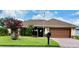 Charming single-story home featuring a well-manicured lawn and mature landscaping at 17329 Se 115Th Ter, Summerfield, FL 34491