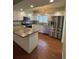 Modern kitchen with stainless steel appliances, granite countertops, and white cabinetry at 17329 Se 115Th Ter, Summerfield, FL 34491