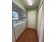Functional laundry room features a washer, dryer, and built-in shelving at 17329 Se 115Th Ter, Summerfield, FL 34491