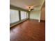 Living room with wood floors and bright windows at 17329 Se 115Th Ter, Summerfield, FL 34491