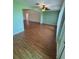 Open floor plan in the living room, showcasing wood floors and natural light at 17329 Se 115Th Ter, Summerfield, FL 34491