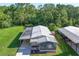 Aerial view of home featuring a metal roof, screened lanai, carport and spacious backyard at 1855 Stacey Dr, Mount Dora, FL 32757