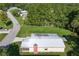 Overhead shot of the home, metal roof, and surrounding neighborhood trees. Includes view of road at 1855 Stacey Dr, Mount Dora, FL 32757