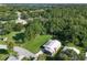 Beautiful aerial perspective highlighting the property's metal roof, lush surroundings, and community at 1855 Stacey Dr, Mount Dora, FL 32757