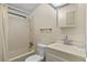 Bright bathroom showcasing a shower-tub combo, vanity, and mirror at 1855 Stacey Dr, Mount Dora, FL 32757