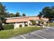 Low-rise building with ample parking, landscaping, and covered walkways at 1855 Stacey Dr, Mount Dora, FL 32757