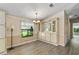 Dining area featuring built-in cabinets, chandelier lighting, and a large window for natural light at 1855 Stacey Dr, Mount Dora, FL 32757