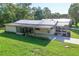 Aerial view of well-kept property, patio, and screened in porch, surrounded by a lush green lawn at 1855 Stacey Dr, Mount Dora, FL 32757