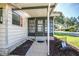 Charming front entrance with a screened porch, providing a welcoming and secure entryway at 1855 Stacey Dr, Mount Dora, FL 32757
