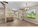Eat-in kitchen with wood-look vinyl flooring, natural light, and a retro light fixture at 1855 Stacey Dr, Mount Dora, FL 32757