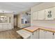 Open kitchen area with wood-look floors, vintage decor, and a view of the living space at 1855 Stacey Dr, Mount Dora, FL 32757