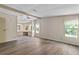 Open living room with wood-look flooring and a view of the built in vanity at 1855 Stacey Dr, Mount Dora, FL 32757