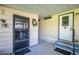 Inviting front porch with a security door, wreath, and blue-carpeted steps leading to the main entrance at 1855 Stacey Dr, Mount Dora, FL 32757