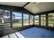 Enclosed porch with large windows offering bright, scenic views of the neighborhood at 1855 Stacey Dr, Mount Dora, FL 32757