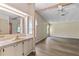 Bright, dual vanity area with warm-toned counters, cabinetry, and views into the adjacent living space at 1855 Stacey Dr, Mount Dora, FL 32757