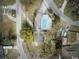 Aerial view of a house with a private pool, driveway, and surrounding greenery at 219 Magnolia Cir, Eustis, FL 32726