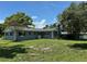 Spacious backyard with lush green lawn and mature trees offers a private and serene setting at 219 Magnolia Cir, Eustis, FL 32726