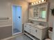 Bright bathroom with double vanity, stylish mirrors, and a tiled walk-in shower at 219 Magnolia Cir, Eustis, FL 32726
