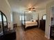 Cozy bedroom featuring wood floors, ceiling fan, and ample natural light at 219 Magnolia Cir, Eustis, FL 32726