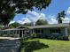 Charming one-story brick home with a covered porch and a well-manicured lawn at 219 Magnolia Cir, Eustis, FL 32726