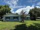 Quaint home with well-maintained lawn and mature trees for shade, offering charm and curb appeal at 219 Magnolia Cir, Eustis, FL 32726