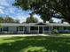 Charming home with a welcoming front porch, well-manicured lawn, and established landscaping at 219 Magnolia Cir, Eustis, FL 32726