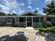 Charming single-story home featuring a welcoming front porch and landscaped yard at 219 Magnolia Cir, Eustis, FL 32726