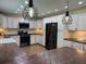 Modern kitchen featuring white cabinets, stainless steel appliances, and dark countertops at 219 Magnolia Cir, Eustis, FL 32726