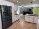 Spacious kitchen with a large island, stainless steel appliances, and sleek white cabinetry at 219 Magnolia Cir, Eustis, FL 32726