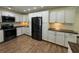 Modern kitchen featuring stainless steel appliances, ample cabinet space and dark hardware at 219 Magnolia Cir, Eustis, FL 32726