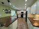 Well-lit kitchen featuring white cabinets, pendant lighting, and modern appliances at 219 Magnolia Cir, Eustis, FL 32726