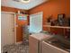 Cozy laundry room with modern appliances, ample shelving, and stylish patterned flooring at 219 Magnolia Cir, Eustis, FL 32726