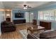 Spacious living room with hardwood floors, ceiling fan, and plentiful natural light at 219 Magnolia Cir, Eustis, FL 32726