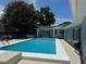 Beautiful backyard pool with a clean concrete surround offers a refreshing escape at 219 Magnolia Cir, Eustis, FL 32726