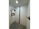 Tiled walk-in shower featuring a mosaic tile floor, showerhead, and tiled inset shelving at 219 Magnolia Cir, Eustis, FL 32726