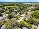 Bird's eye view of homes in lush, tree-filled neighborhood near lake and open green space at 2389 Grand Poplar St, Ocoee, FL 34761