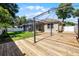 View of back yard featuring a deck, screened-in porch, and manicured lawn at 2389 Grand Poplar St, Ocoee, FL 34761