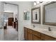 Bathroom boasts a double sink vanity with warm wood cabinets and tiled floors at 2389 Grand Poplar St, Ocoee, FL 34761