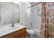 Well-lit bathroom features a shower-tub combo and a wood-tone vanity at 2389 Grand Poplar St, Ocoee, FL 34761