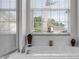 Relaxing bathtub with tile surround and a large window offering natural light and privacy at 2389 Grand Poplar St, Ocoee, FL 34761