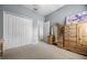 Bedroom featuring a large closet, dresser, and neutral carpeting at 2389 Grand Poplar St, Ocoee, FL 34761