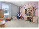 Playful bedroom featuring colorful decor, carpet and a window at 2389 Grand Poplar St, Ocoee, FL 34761