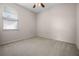 Bedroom with neutral carpeting, ceiling fan, and natural light from a window at 2389 Grand Poplar St, Ocoee, FL 34761