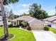 Lovely home features a large front lawn, well-maintained landscaping, and a two-car garage for convenient parking and storage at 2389 Grand Poplar St, Ocoee, FL 34761