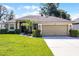 Charming single-story home with a manicured lawn, complemented by mature landscaping and a spacious two-car garage at 2389 Grand Poplar St, Ocoee, FL 34761