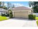 Attractive home featuring a well-kept lawn, manicured shrubs, and a convenient two-car garage with a neutral-toned door at 2389 Grand Poplar St, Ocoee, FL 34761