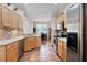 Bright kitchen with stainless steel appliances, tile floors, and light wood cabinets at 2389 Grand Poplar St, Ocoee, FL 34761