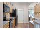 Kitchen with stainless steel appliances and tile floors, leading to doorway at 2389 Grand Poplar St, Ocoee, FL 34761